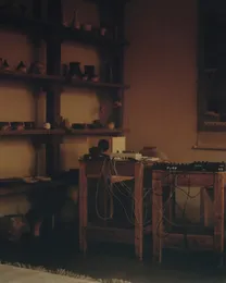 The Circle performance room – shelves of ceramics beside Huh Namhoon's cabled sound equipment in warm light